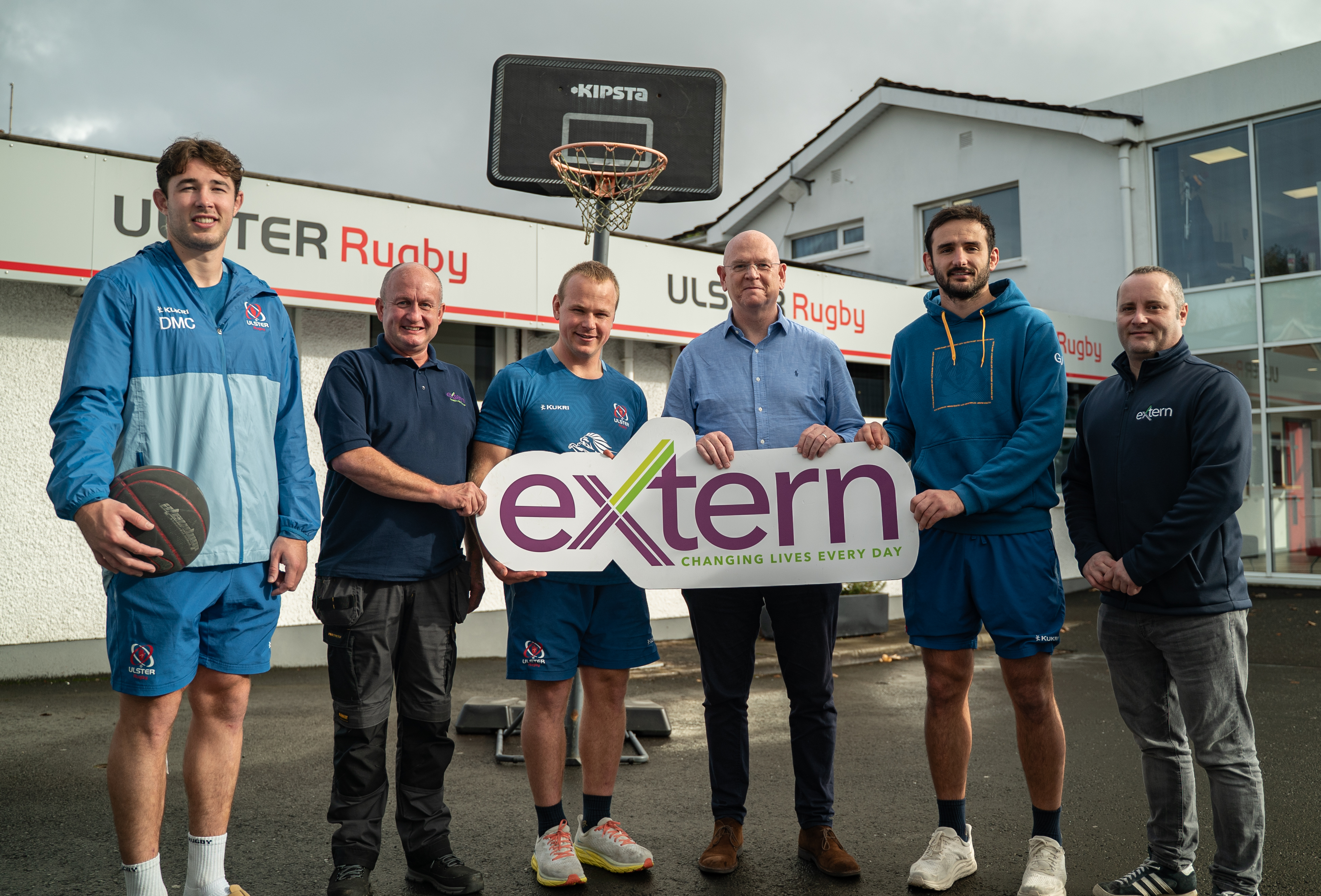 Extern staff and CEO Colin Hayburn receiving donation of basketball net from Ulster Rugby