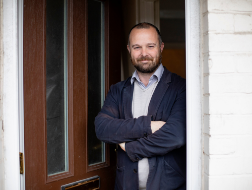 Project Manager Declan Morris standing at the entrance to an Extern Home