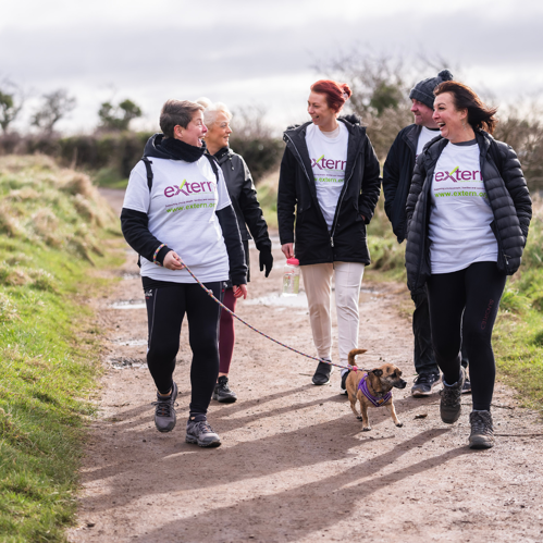 Extern staff walking with service users in the countryside