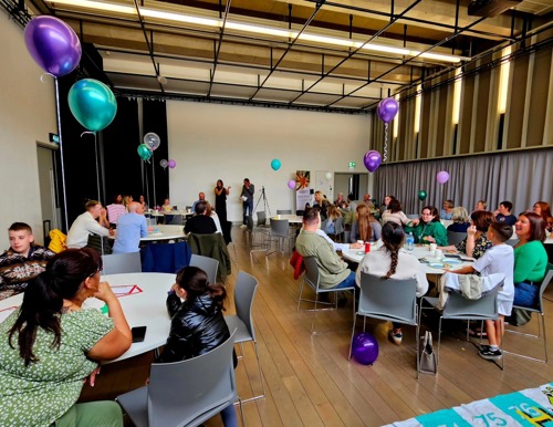 View of a packed room at the Extern Volunteer Week celebration event