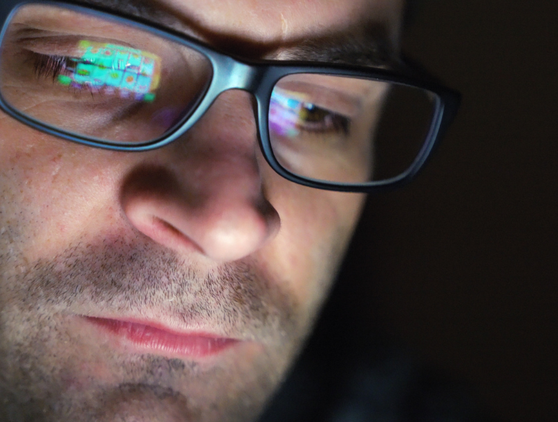 Man looking at computer screen gambling