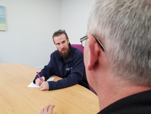 Criminal Justice Floating Support Manager talking with client at a table