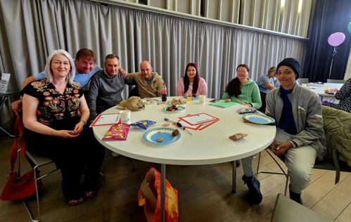 Extern volunteers sitting at a table at the volunteer event